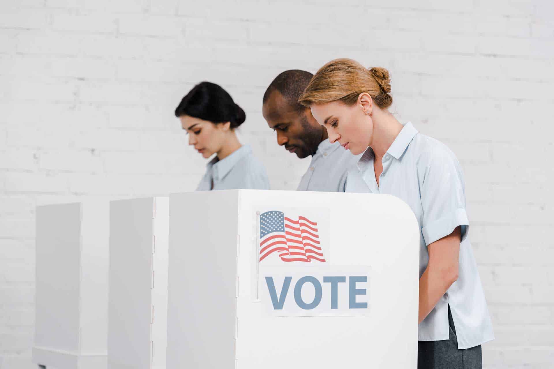 People standing at voting booths