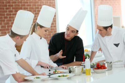 chef teaching students to cook