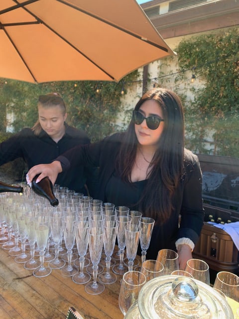 Abigail Castillo pouring brut for a wedding ceremony at Folktale's Rose Vineyard